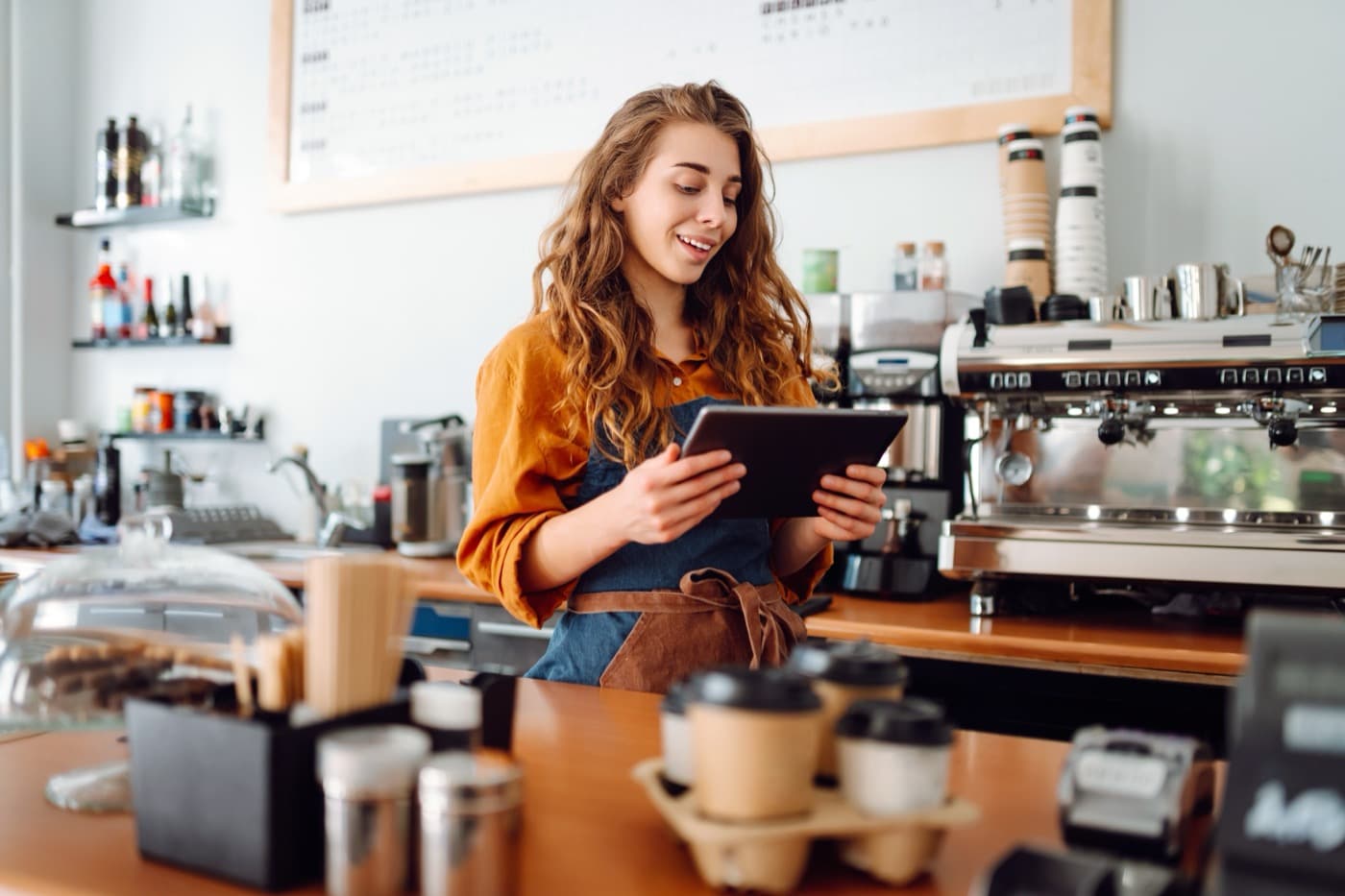 Small business owner managing operations from their cafe